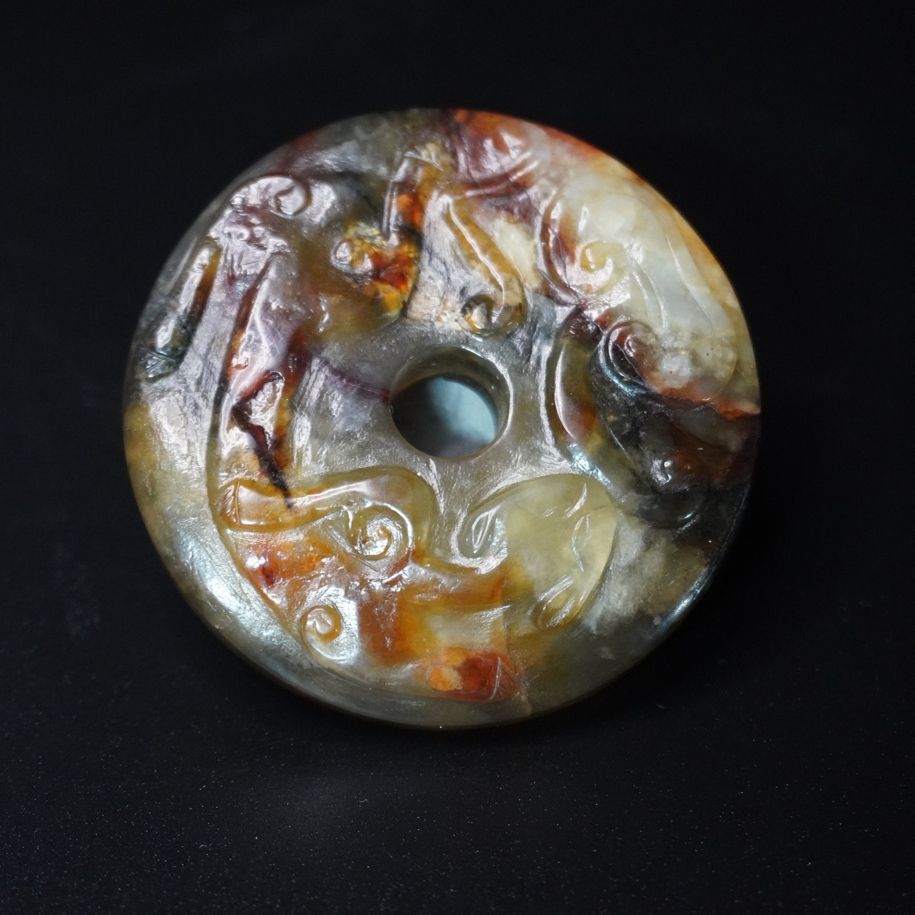 On a Five Dynasties period (A.D. 907–960) Jade Bi with Polychrome Patina  五色沁玉璧